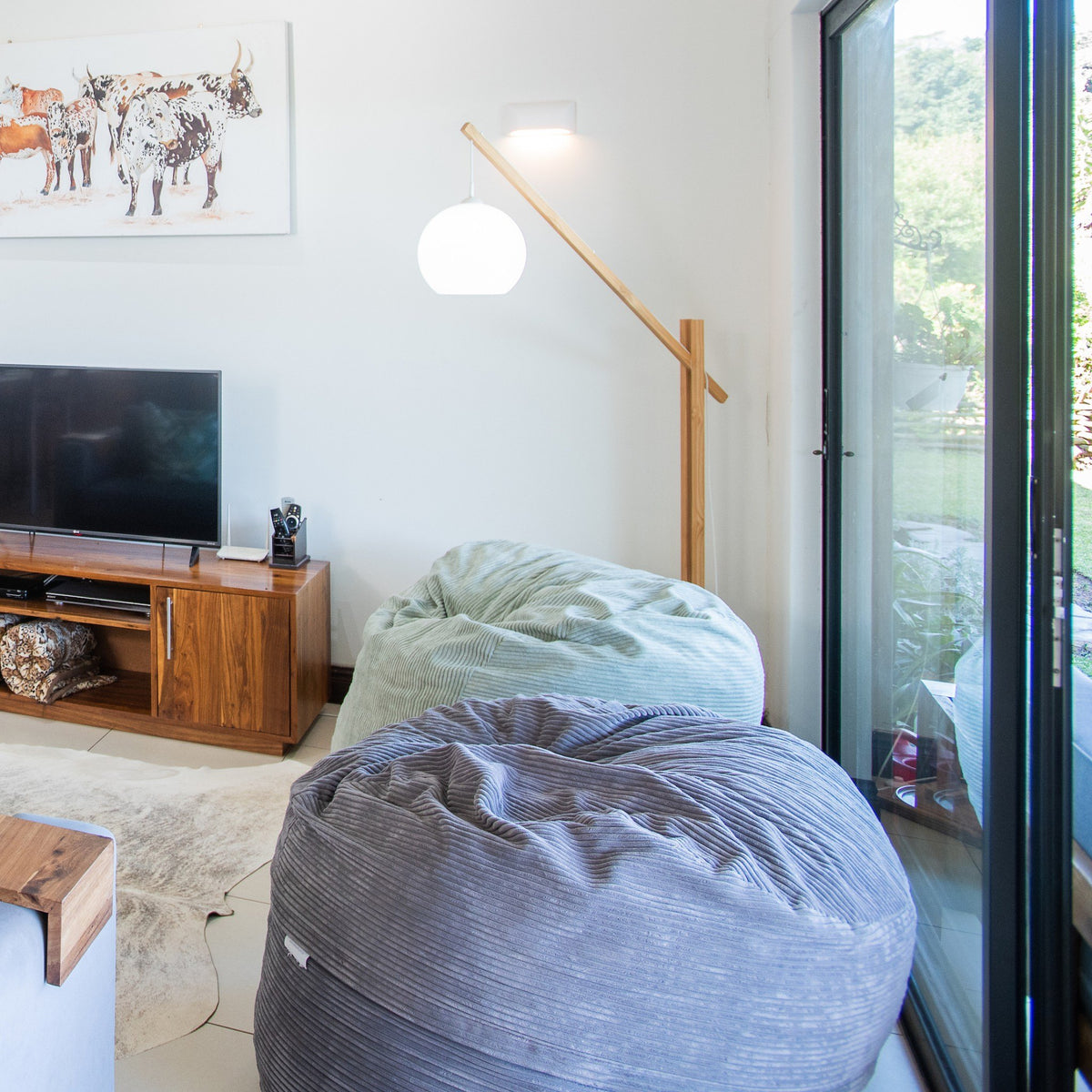 Graphite corduroy Shloomfy beanbag in an open-plan living room