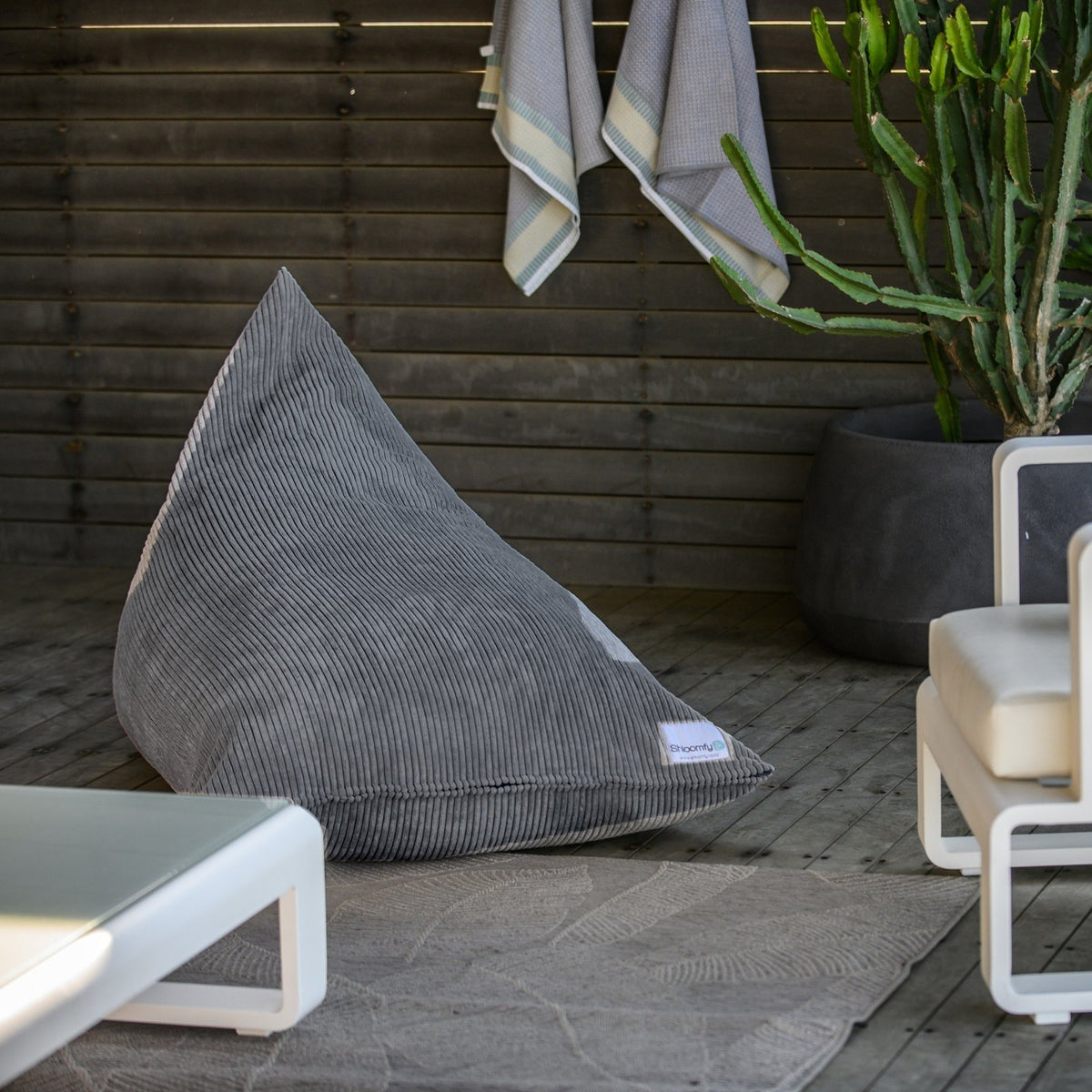 Graphite corduroy Shloomfy lounger on a covered patio