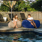 Navy and Sand Shloomfy patio beanbags on a pool deck