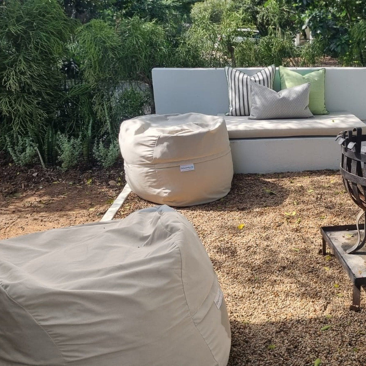 Putty Shloomfy patio beanbag beside a garden firepit