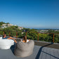 Putty and Off White Shloomfy patio beanbags on a rooftop with a sea view